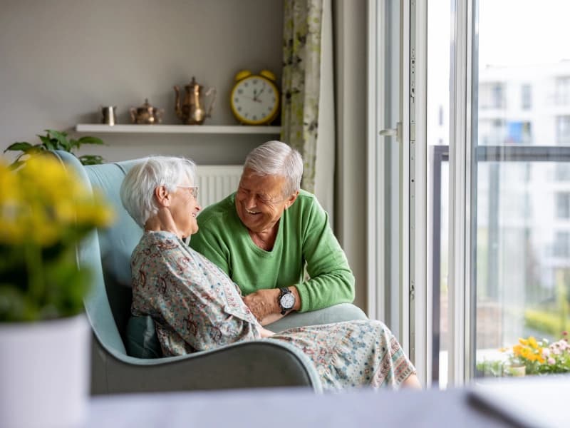 A caregiver warmly supporting an elderly resident